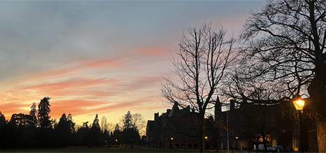 Beautiful pink evening sky above a silhuetted Abingdon School grounds
